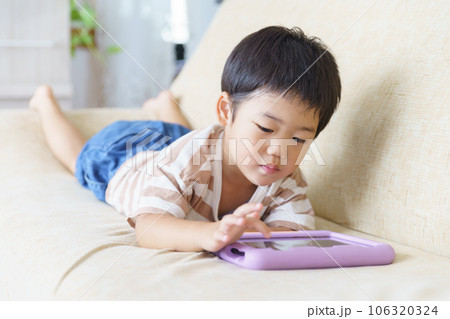 タブレットで動画を見る男の子 タブレットで動画を見る男の子 106320324