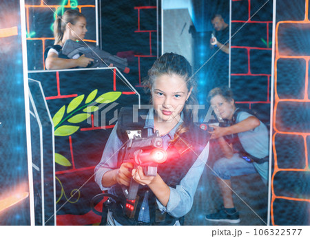 Portrait of teenager girl with laser gun having fun with her fam 106322577