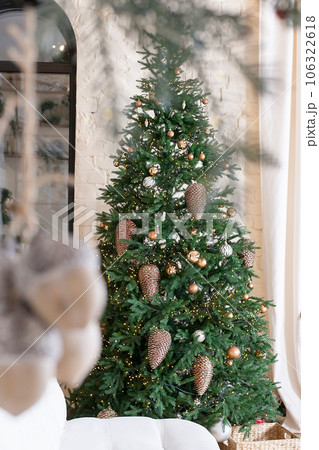 Beautiful Christmas tree in decorated living room. Festive interior. 106322618