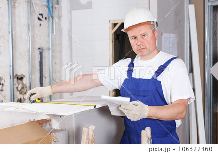 Contractor installing drywall construction Contractor installing drywall construction 106322860