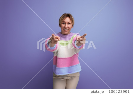 charming blond young woman showing class ahead on purple background with copy space 106322901