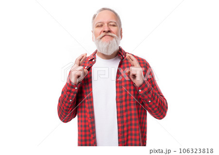 handsome 60s middle aged mature man in stylish shirt crossed his fingers handsome 60s middle aged mature man in stylish shirt crossed his fingers 106323818