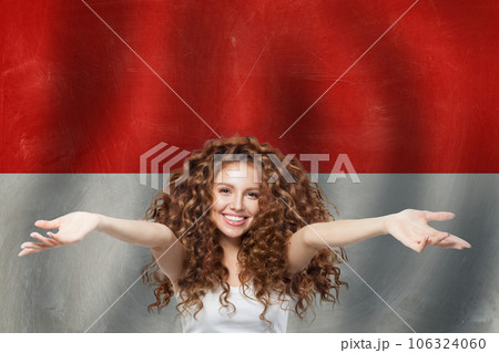 Happy woman against red and white flag banner background 106324060