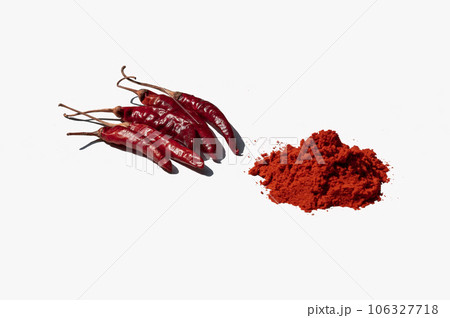 Red chili peppers and powder isolated on a white background. Selective focus Red chili peppers and powder isolated on a white background. Selective focus 106327718