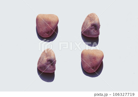 Red stones on a white background, top view, flat lay. Red stones on a white background, top view, flat lay. 106327719