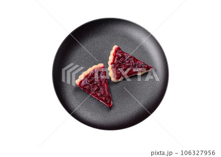 Delicious fragrant sweet pie with cherry berries on a ceramic plate Delicious fragrant sweet pie with cherry berries on a ceramic plate 106327956