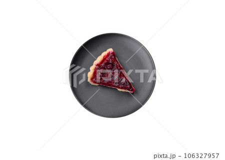 Delicious fragrant sweet pie with cherry berries on a ceramic plate Delicious fragrant sweet pie with cherry berries on a ceramic plate 106327957