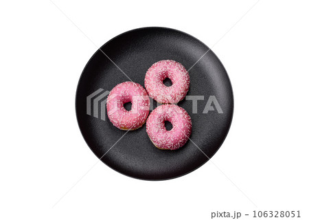 Delicious fresh sweet donuts in pink glaze with strawberry filling Delicious fresh sweet donuts in pink glaze with strawberry filling 106328051