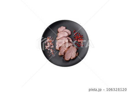 Delicious beef steak with salt, spices and herbs on a ceramic plate 106328120