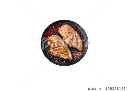 Delicious fresh grilled chicken fillet with salt, spices and herbs on a ceramic plate 106328121