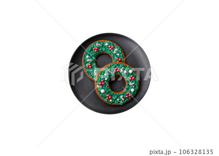 Delicious Christmas gingerbread cookies on a dark textured concrete background Delicious Christmas gingerbread cookies on a dark textured concrete background 106328135