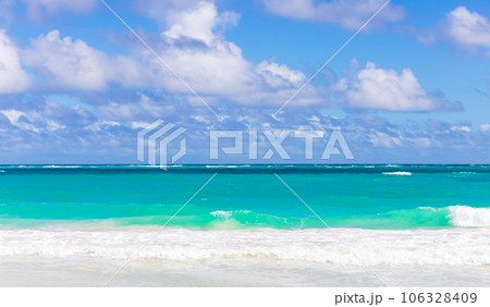 Caribbean Sea shore waves are under blue sky on a sunny day 106328409