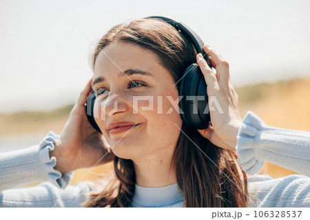 Young sunlit cute excited traveler tourist woman 20s wearing shirt summer casual clothes headphones Young sunlit cute excited traveler tourist woman 20s wearing shirt summer casual clothes headphones 106328537