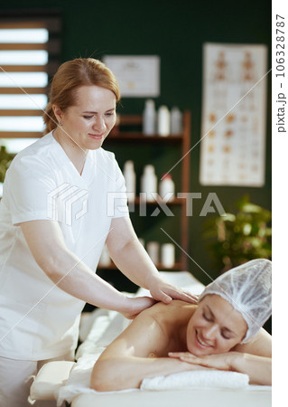 medical massage therapist in spa salon massaging client medical massage therapist in spa salon massaging client 106328787