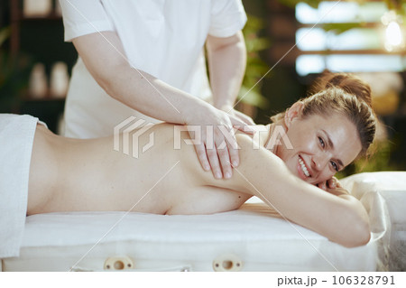 massage therapist in massage cabinet massaging client 106328791