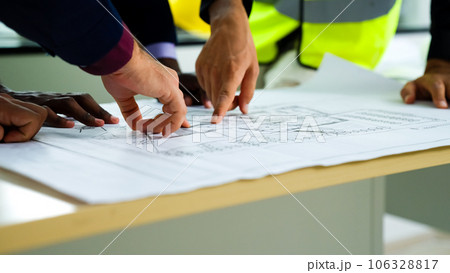 Construction engineers team using blueprint of project plan brainstorming Construction engineers team using blueprint of project plan brainstorming 106328817