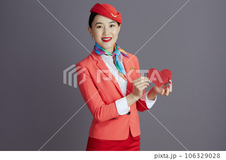 happy stylish air hostess asian woman isolated on grey 106329028
