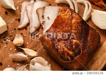 still life of food in a rural style on a dark wood background, sliced lard and garlic, cheese and onion, concept of fresh vegetables and healthy food still life of food in a rural style on a dark wood background, sliced lard and garlic, cheese and onion, concept of fresh vegetables and healthy food 106330116