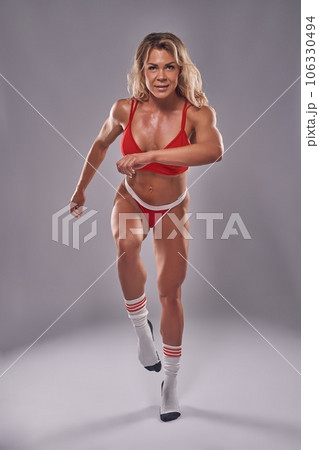 Muscular woman doing fitness in red sport underwear Muscular woman doing fitness in red sport underwear 106330494