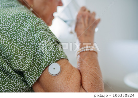 Senior woman drinking water to better manage her diabetes. 106330824