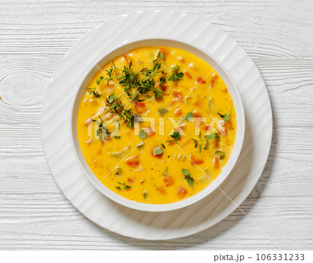 Beer cheese soup with vegetables and thyme 106331233