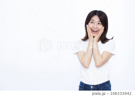白い背景の前で笑顔でビックリしている30代の女性 白い背景の前で笑顔でビックリしている30代の女性 106333042