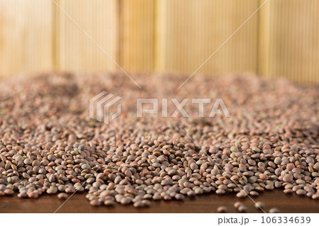 Background with raw lentil grains on wooden surface, nutritious food Background with raw lentil grains on wooden surface, nutritious food 106334639
