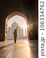tourist standing in front entrance gate of Taj Mahal indian palace. Islam architecture. Door to the mosque  106334762