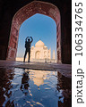 tourist standing in front entrance gate of Taj Mahal indian palace. Islam architecture. Door to the mosque  106334765