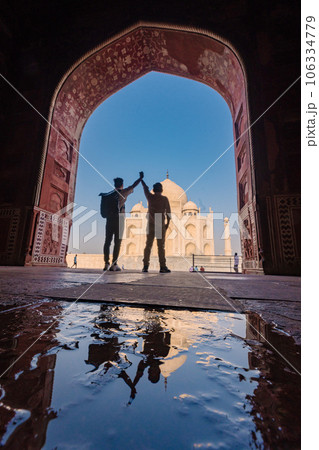 two gay lover standing in front of Taj Mahal indian palace. Islam architecture. two gay lover standing in front of Taj Mahal indian palace. Islam architecture. 106334779