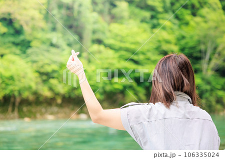 指先のハート、背後に広がる緑 106335024