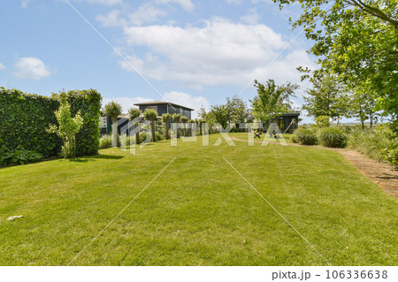 an outdoor area with green grass, trees and blue sky in the photo is taken from behind it on a sunny day an outdoor area with green grass, trees and blue sky in the photo is taken from behind it on a sunny day 106336638