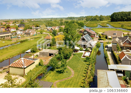 an aerial view of some houses in the country side with water running through them and trees growing on both sides an aerial view of some houses in the country side with water running through them and trees growing on both sides 106336660