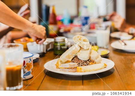 Fresh homemade variety bread on a white at breakfast table. Fresh homemade variety bread on a white at breakfast table. 106341934