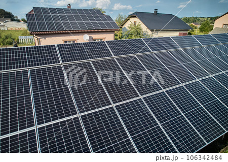 Aerial top view of new modern house cottage with solar photovoltaic panel system on house roof 106342484