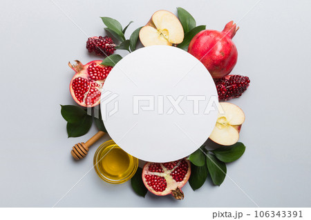 Flat lay composition with Blank flyer poster and symbols jewish Rosh Hashanah holiday attributes on colored background, New Year holiday Traditional. Top view with copy space mock up 106343391