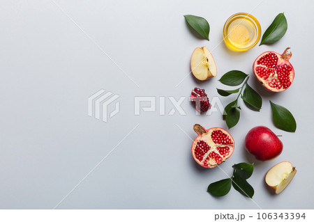 Flat lay composition with symbols jewish Rosh Hashanah holiday attributes on colored background, Rosh hashanah concept. New Year holiday Traditional. Top view with copy space Flat lay composition with symbols jewish Rosh Hashanah holiday attributes on colored background, Rosh hashanah concept. New Year holiday Traditional. Top view with copy space 106343394