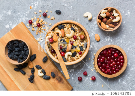 Cooking a wholesome breakfast. Granola with Various dried fruits and nuts in a bowl. The concept of a healthy dessert. Flat lay, top view with copy space 106343705