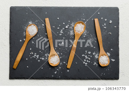 salt on many wooden spoon on wood background. Spoons with different salt 106343770