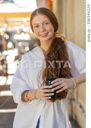 Teen child girl enjoying drinking morning coffee hot drink, relaxing, taking a break in city street Teen child girl enjoying drinking morning coffee hot drink, relaxing, taking a break in city street 106344224