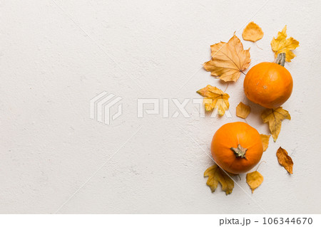 Autumn composition. Pattern made of dried leaves and other design accessories on table. Flat lay, top view Autumn composition. Pattern made of dried leaves and other design accessories on table. Flat lay, top view 106344670