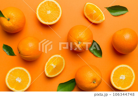 Fruit pattern of fresh orange slices on colored background. Top view. Copy Space. creative summer concept. Half of citrus in minimal flat lay Fruit pattern of fresh orange slices on colored background. Top view. Copy Space. creative summer concept. Half of citrus in minimal flat lay 106344748