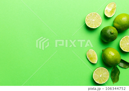 Lime fruits with green leaf and cut in half slice isolated on white background. Top view. Flat lay with copy space Lime fruits with green leaf and cut in half slice isolated on white background. Top view. Flat lay with copy space 106344752