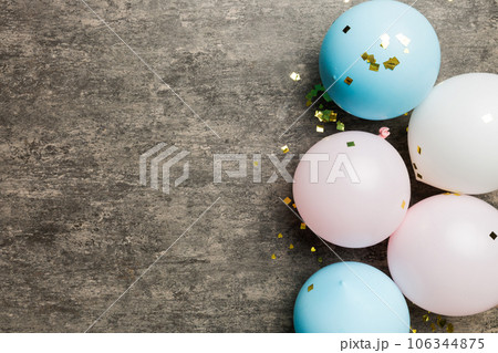 Background with fastive air balloons of round shape and confetti, multicoloured top view. Birthday party background Background with fastive air balloons of round shape and confetti, multicoloured top view. Birthday party background 106344875