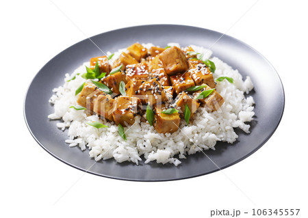 plate of rice and fried tofu with sesame seeds on white background 106345557