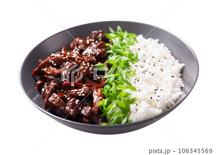 plate of  teriyaki beef, rice, green onion and sesame seeds on white background 106345569