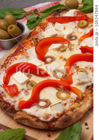 italian pizza with bell pepper, cheese and olives 106347664