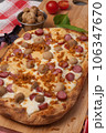 italian pizza with sausages, mushrooms and mozzarella 106347670