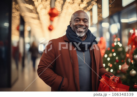 Christmas sale concept. Middle aged smiley African American man in a mall. Christmas sale concept. Middle aged smiley African American man in a mall. 106348339