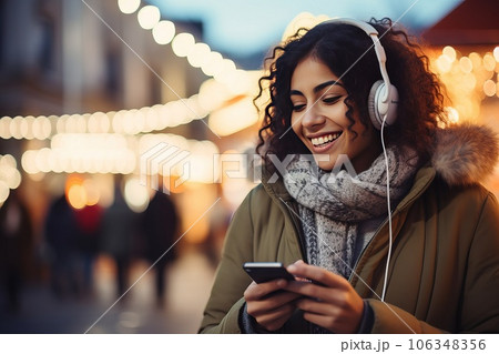 Young smiley woman in headphones outdoor. 106348356